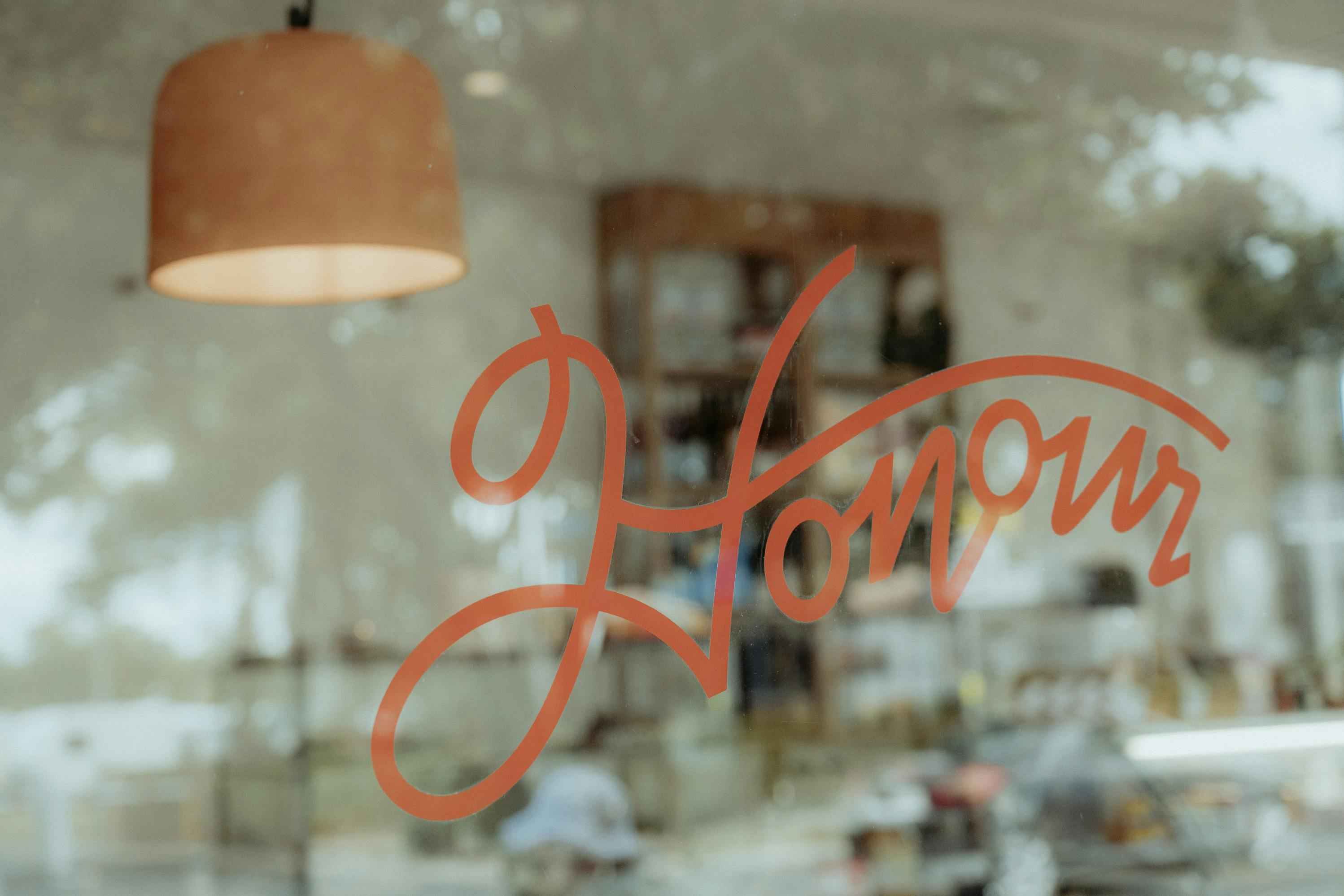 a handwritten red window decal that says